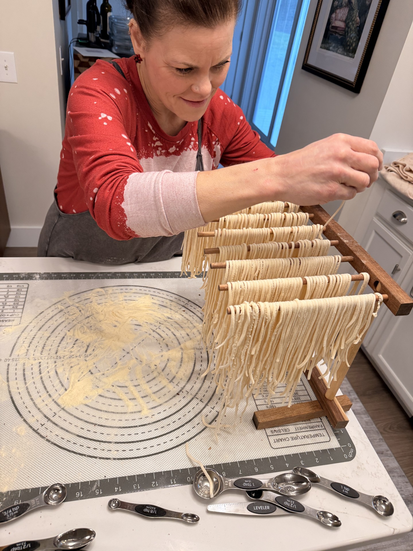 Holly placing pasta on the drying rack